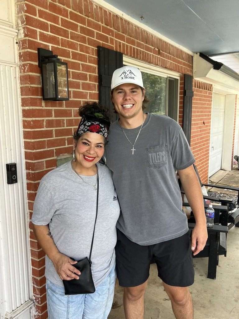 Crystal standing on her porch with Wilson from X Home after we helped her stop her foreclosure